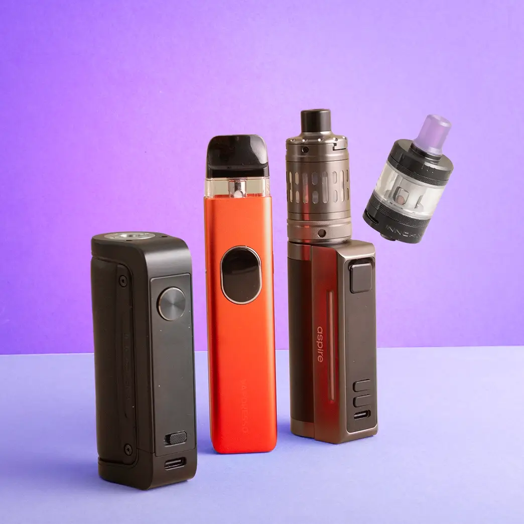 Pod kit, sub ohm kit, mod and tank lined up together on a purple/blue background